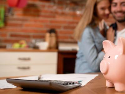 couple putting money in a piggy bank